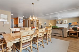 Bathed in natural light and anchored by a classic fireplace, the elegant dining room at Resort Plaza 5064 creates a warm and inviting atmosphere for shared meals and quality time together in this prem