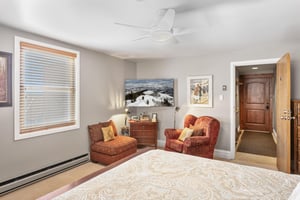 Inviting sitting area in the king bedroom at RP5064, with cozy upholstered chairs and a private door leading to the ensuite.