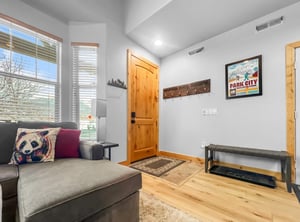 Step inside to a bright, welcoming entryway where natural light fills the space and warm wood floors greet you. Kick off your boots, hang your gear, and settle in—your mountain escape starts here.