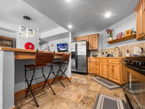 Your fully equipped kitchen invites homecooked meals with warm wood cabinetry, stainless appliances, and a cozy breakfast bar where you can sip morning coffee.