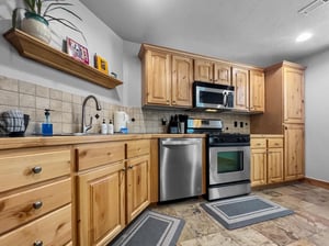 Your fully equipped kitchen features warm wood cabinetry, stainless steel appliances, and everything you need to prepare homecooked meals during your stay.