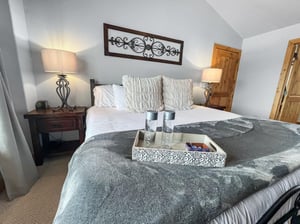 Sink into plush linens and soft textured pillows in your restful bedroom retreat. Warm lamplight and thoughtful touches create a cozy, welcoming space where youll drift off easily after each days ad