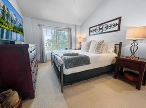 Your peaceful retreat awaits with a plush bed, soft linens, and natural light streaming through the window. Elegant touches and thoughtful decor create a cozy sanctuary where you can truly unwind.
