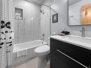 Step into a bright, modern bathroom with sleek marbleinspired tile and ample counter space for all your essentials. The tub offers a relaxing soak after your adventures.