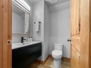 Step into your freshly updated bathroom, where a sleek floating vanity and soft gray walls create a calming retreat. Fresh towels await and thoughtful amenities are within reach.