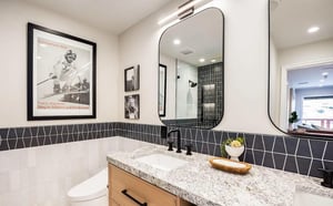 Freshen up in your modern bathroom with stylish geometric tiling, sleek fixtures, and natural light streaming in—a spalike retreat that blends artful design with everyday comfort.