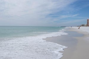 The tide rolling in on the beach adjacent to Inlet Reef Club in Destin.