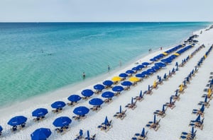 Birds eye view of the beach with lounge chairs and umbrellas