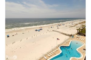 View of the pool and beach from above at Ocean House Gulf Shores