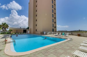 Outdoor swimming pool and sun deck next to Navarre Towers