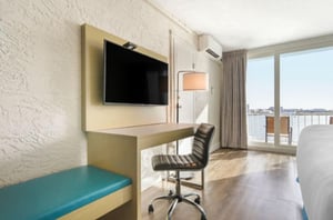 A guest room TV and desk.