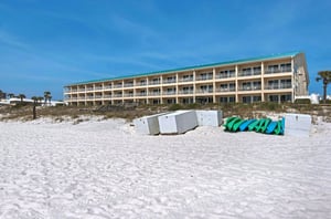 One of the complexs two buildings positioned beside the beach.