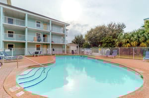 Gulfviews kidneyshaped pool and tile sundeck.