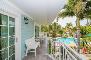 An outdoor terrace with a chair at Tropical Breeze Resort in Siesta Key Florida