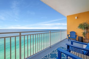 A private balcony with lounge chairs overlooking the Gulf of Mexico at Splash Resort