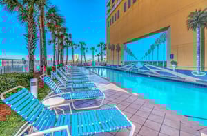 Lounge chairs next to the outdoor swimming pool at Sterling Reef in Panama City Beach Florida