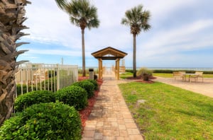 A boardwalk and gated entrance to the private beach