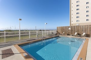 The complex features a refreshing aqua swimming pool surrounded by a spacious sundeck.