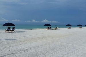 Beach lounge chairs and umbrellas provide frontrow seats to the Gulf.