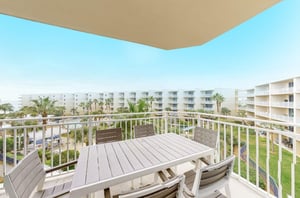A private balcony with a dining table and chairs at Waterscape in Fort Walton Beach Florida
