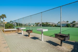 A grilling patio next to the tennis courts