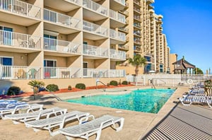 The outdoor pool and pool deck in front of Four Winds in Orange Beach Alabama