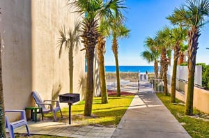 Charcoal grills next a walkway at Four Winds in Orange Beach Alabama