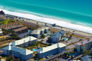 The quaint complex sits directly across from the beach