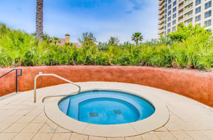 A crystalclear hot tub with tropical landscaping provides a private place for relaxing