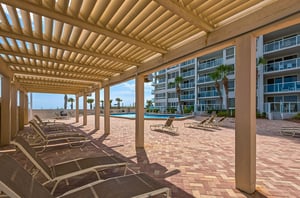 Lounge chairs under a gazebo offer a shaded area to relax.