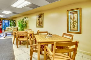 The lobby with chairs and tables at the Palms in Orange Beach Alabama
