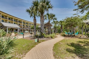 Towering palm trees reach toward the sun amid Beach Resorts lush landscaping.