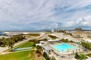 Scenic view of the community pool, shuffleboard and East Pass beyond