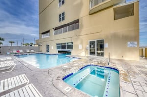 The indooroutdoor pool and outdoor hot tub in front of Island Royale in Gulf Shores Alabama