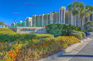 View from the street of the Phoenix VII and the propertys entry sign