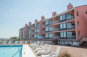 Unwind on the spacious pool deck at Palm Beach Club