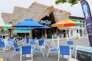 The exterior of the restaurant in front of the hotel with dining chairs and tables