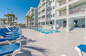 Lounge chairs next to the outdoor swimming pool at Grand Caribbean in Orange Beach Alabama
