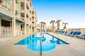 The outdoor swimming pool stretching in front of Grand Caribbean in Orange Beach Alabama