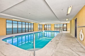 The indoor swimming pool next to windows at Grand Pointe in Orange Beach Alabama