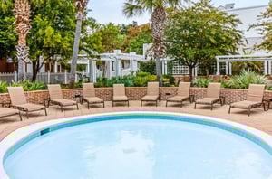 A Sandestin swimming pool with lounge chairs.