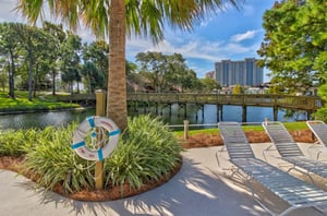 A sandestin boardwalk crosses over a community lake.