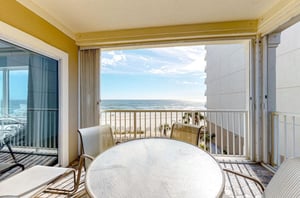 A private balcony with dining chairs and table at Marlin Key in Orange Beach Alabama