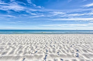 The white sandy beaches in front of the water in Orange Beach Alabama