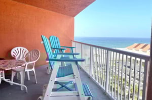 Chairs and table on a private balcony overlooking the Gulf of Mexico