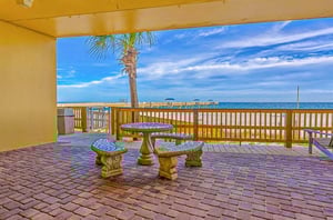 A covered stone picnic table overlooking the beach at Emerald Skye