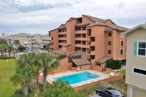 Relax by the outdoor pool at Gulf Winds