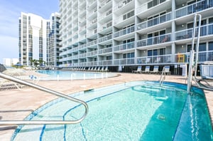Balconies look out over shimmering community pools
