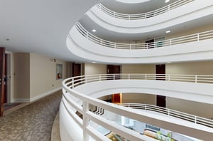 Condo entrances open from hallways encircling an atrium.