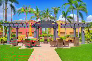 A brightly colored Fort Myers rental condo with an outdoor commonarea patio.